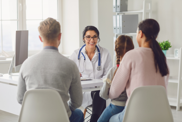 Doctor talking to patients in her office